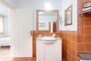 a bathroom with a sink and a mirror at Villa Palm Mar in Palm-mar