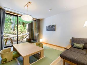 a living room with a couch and a table at Hakone Suishoen in Hakone