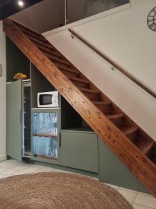 a staircase in a living room with a shelf under the stairs at Studio Snäckeberg in Åsa