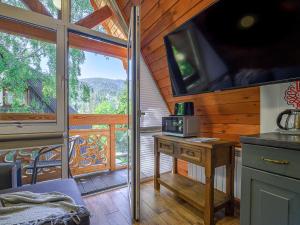 a kitchen with a balcony with a microwave on a table at VisitZakopane - Willa Plan Apartments in Zakopane