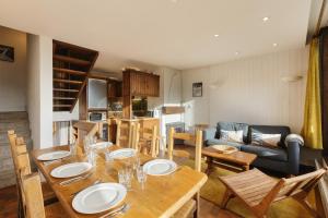 a kitchen and living room with a table and chairs at La Maison De Montroc - Happy Rentals in Chamonix-Mont-Blanc