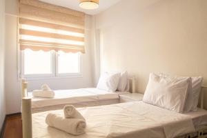 Dos camas en una habitación con toallas. en Vibran, en Izmir