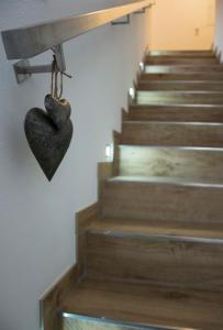 a heart hanging on a wall next to a stairway at Haus Schatzl in Bad Aussee