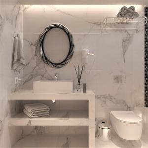 a white bathroom with a sink and a mirror at Eagles Nest in Pefki