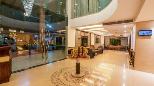 a lobby with a table in the middle of a building at Best Western Merrion in Amritsar