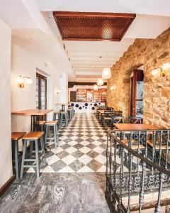 a restaurant with a checkered floor and tables and chairs at Alvar Fañez in Úbeda