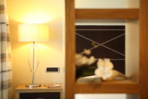 a lamp on a table next to a bunk bed at Hotel Cristallo in Giulianova