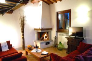a living room with a couch and a fireplace at La Finestra su Cortona in Cortona