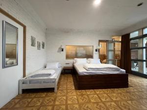 a bedroom with two beds in a room at Villa Bokiko in Puncak