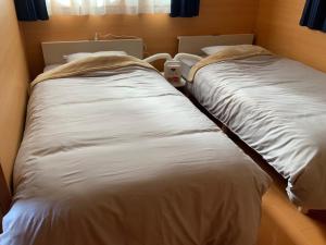 twee bedden naast elkaar in een kamer bij AZ Hotel - Vacation STAY 56058v in Akaoki