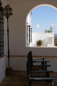 a chair sitting in a room with a window at Cortijo El Solano in Antequera