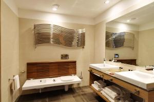 a bathroom with two sinks and a large mirror at Hotel Cristallo in Giulianova