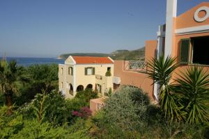 a house with a view of the ocean at Mounda Beach Hotel in Skala Kefalonias