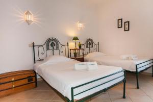 two twin beds in a room with white walls at Apartment T2 Alvor in Alvor