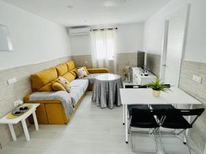 a living room with a couch and a table at AITA CASA BARBATE in Barbate