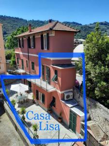 a large pink house with the words casa ica on it at Casa Lisa in Finale Ligure