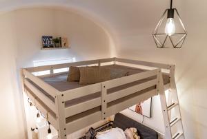 a bunk bed in a room with a staircase at Little Universe in Liptovský Mikuláš