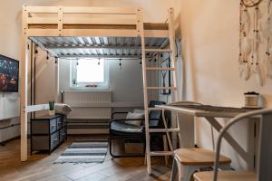 a room with a bunk bed and a desk at Little Universe in Liptovský Mikuláš