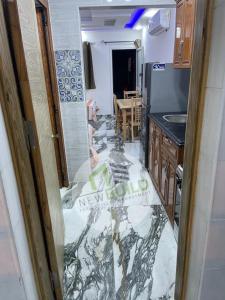 a kitchen is being remodeled with a marble floor at ستوديو المعموره Jerma apartments in Alexandria