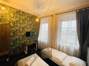 a hotel room with two beds and a window at Boogie ApartHouse Old Town in Wrocław