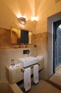 a bathroom with a sink and a mirror at Riad Adore in Marrakesh