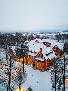 an aerial view of a building covered in snow at Pałac Margot Nature&SPA in Karpacz