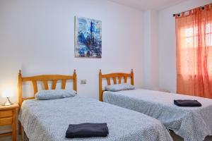 A bed or beds in a room at Apartamento en el centro de Portosin