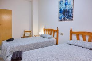 A bed or beds in a room at Apartamento en el centro de Portosin