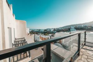 a balcony with a view of a city at Mr & Mrs White Mykonos in Platis Gialos