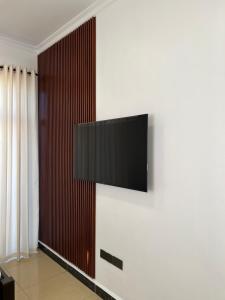 a flat screen tv hanging on a wall at Dreams Hotel Zanzibar in Zanzibar City