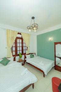 Ένα ή περισσότερα κρεβάτια σε δωμάτιο στο VŨ NHI HOTEL ĐÀ LẠT