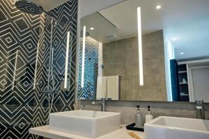 a bathroom with a sink and a mirror at TUI BLUE Bahari Zanzibar in Pwani Mchangani