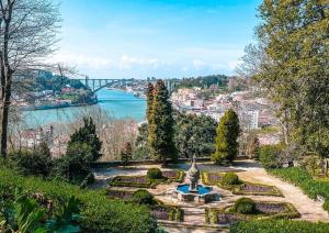 um jardim com uma estátua e vista para um rio em Lapa City Flat Porto - by Guest SPA em Porto