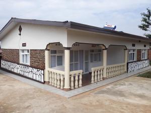 a house with a porch and a balcony at BIZI HOMES in Kigali