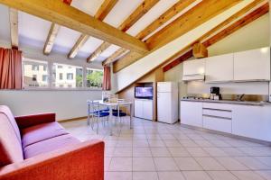 a kitchen with a couch and a table at Hotel Residence Zust in Verbania