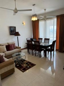 a living room with a dining room table and chairs at Hedges Court Residencies -Town Hall- 2 Room 3 Bed Apartment in Colombo