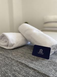 a towel laying on top of a bed with a bar at T2 centre-ville place d'Armes Clim-Wifi in Toulon