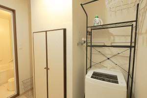 a bathroom with a washer and dryer in a room at STAY IN ASAHIKAWA99 in Asahikawa