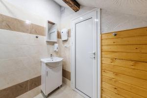 a bathroom with a white toilet and a sink at Sofia Folklore Life Apartment in Sofia
