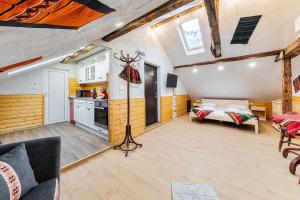 a large room with a bed and a kitchen at Sofia Folklore Life Apartment in Sofia
