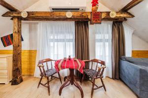 a dining room table with two chairs and a couch at Sofia Folklore Life Apartment in Sofia