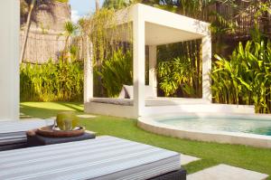 a backyard with a swimming pool and a fountain at Villa Alice in Seminyak
