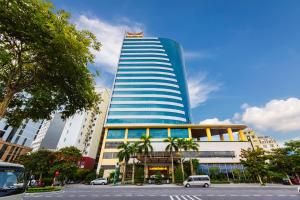 a tall building with a flag on top of it at Muong Thanh Grand Ha Long Hotel in Ha Long