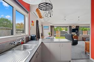 a kitchen with a sink and a large window at Thyme Away - Clyde Holiday Home in Clyde