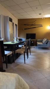 a dining room with a table and chairs and a couch at Apartments in Ramada 2 Complex in Bansko