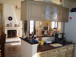 a kitchen with a counter top and a kitchen with a fireplace at Villa with breathtaking views and private beach in Agios Dimitrios