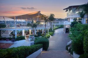 a building with a walkway next to a building at Hotel Village Scoglio Della Galea in Capo Vaticano