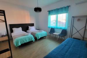 a hotel room with two beds and a window at Casa Borges in Charneca