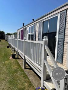 a row of mobile homes parked next to each other at Golden Palm Resort - The Pastures 57 - TP57 in Chapel Saint Leonards