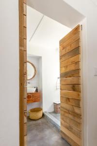 a bathroom with a wooden door in a room at Arendsig Wine Estate & Cottages in Bonnievale